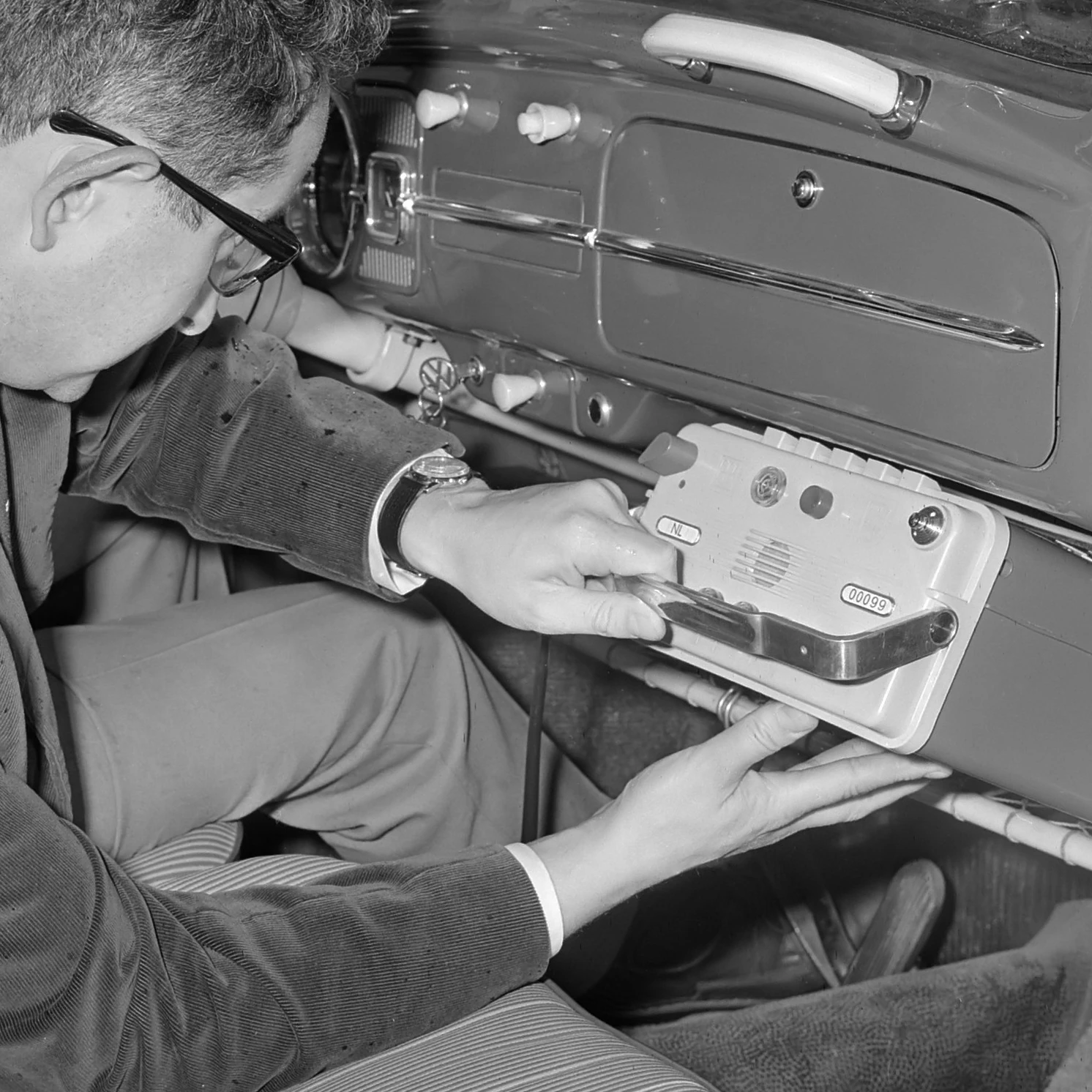 Dr R.J. Meijer with an early pager in his car, 17 September 1964.
